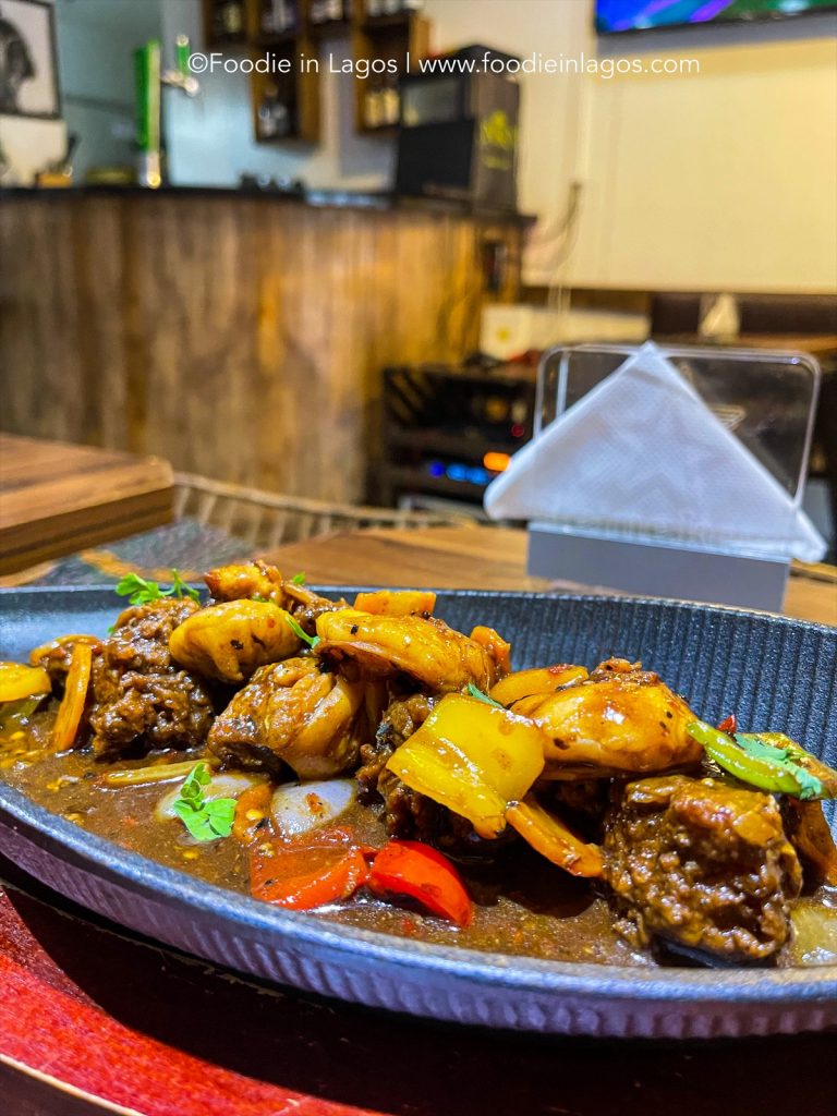 Mainland foodies get in here! We have something for you. So we visited Kuti’s bistro which is located at Ogundana Street, off Allen, Ikeja. The restaurant is a quaint, cosy space owned by Yetunde Kuti who is also the head chef. The decor has a nice African feel to it – there are also pictures of Femi and Seun Kuti and other artwork nicely hung around the wall. MAIN On to the food! I went right to the main course as I had already eaten earlier so I didn’t want to order too much. For my main meal, I had the Chef’s Special Kalakuta Show – a battered fish fillet and prawn in a rich hot bell peppers sauce served with special fried rice which cost ₦6,000. The sauce was fantastic and the right amount of spicy. I give this a solid 8/10 👌! DRINK For my drink I had the freakshake which was actually new on the menu. This cost ₦5000. This also doubled as a dessert as it came with this delicious waffle topping. This was honestly a 10/10, it was so tasty and filling too! I left Kuti stuffed. Overall experience here was great, I’d give it an 8/10. The food was really good and I totally recommend the freakshake when you eventually visit.