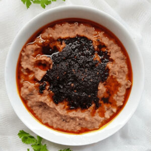 Ewa agoyin and sauce in a bowl